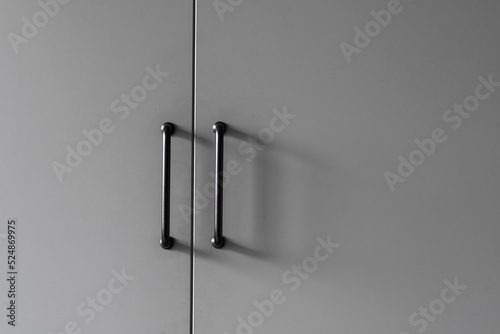 closeup of wood cupboard door and metal handle
