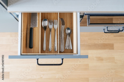 wooden cutlery drawer in kitchen, top view photo