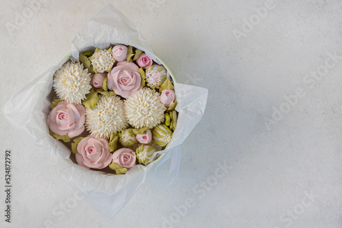 Zephyr bouquet of flowers in a pink box on a gray background  top view  copy space