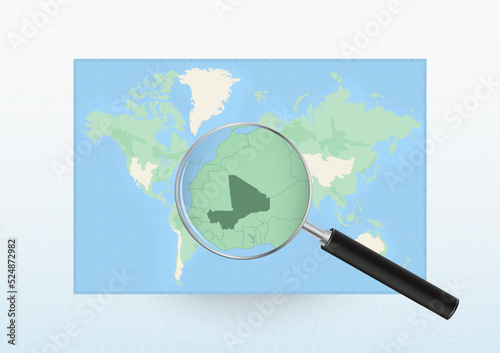 Map of the World with a magnifying glass aimed at Mali, searching Mali with loupe.