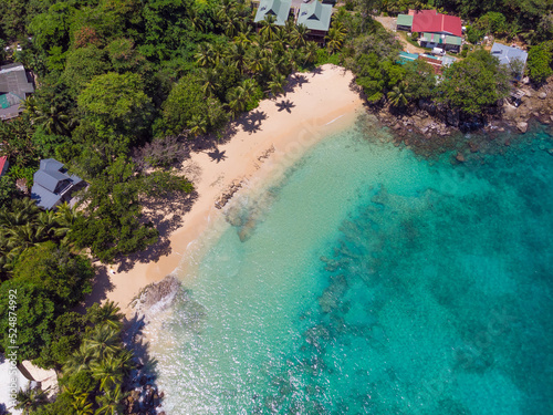 Aerial view from drone of Top Soleil beach at Mahé Island taken in the afternoon light above the ocean
