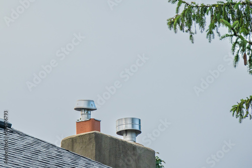 Chimney caps on brick chimney s on multi unit apartment buildings  in an older residential neighbourhood of Toronto