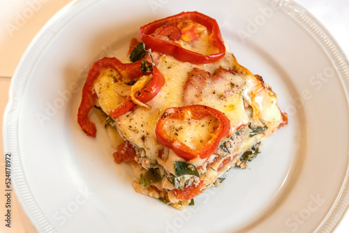 lasagna piece plate with minced meat and melted cheese