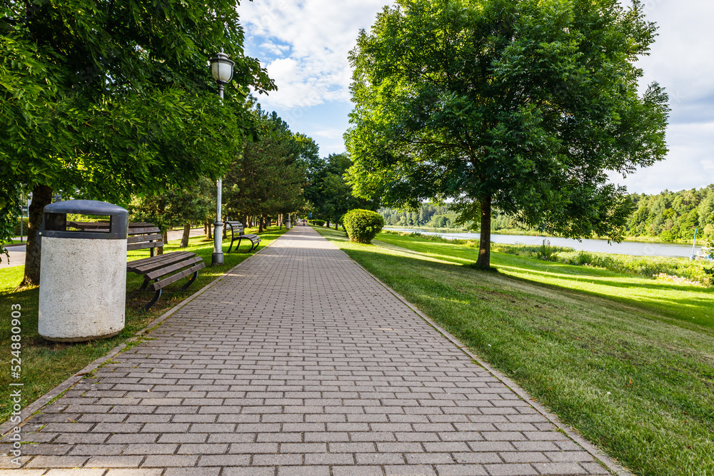 Urban recreation and outdoor activities area. The row of oak trees, grassy lawn, and pathway