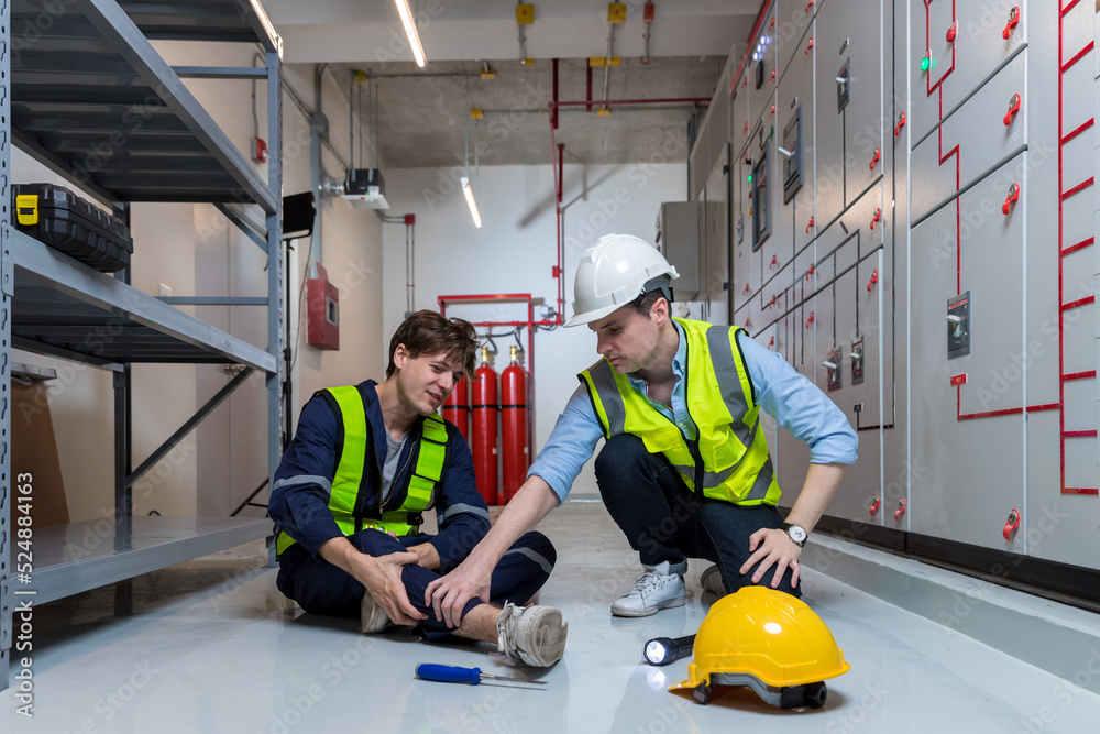 First aid support accident at work of worker at factory. Male worker has an accident on the floor in warehouse site First aid support accident at work of worker at factory. Male worker has an accident on the floor in warehouse site