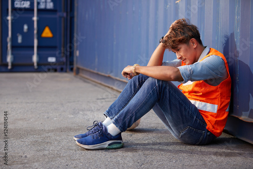 factory worker or engineer feeling tired and disappointed from work in containers warehouse storage