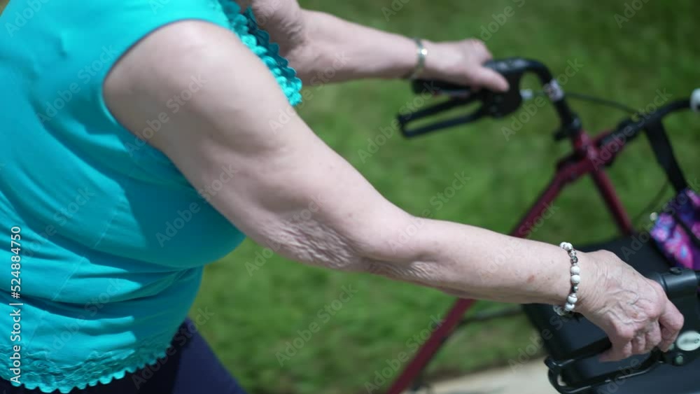 Closeup of senior elderly womans hands pushing a walker outside. Closeup of senior elderly womans hands pushing a walker outside.