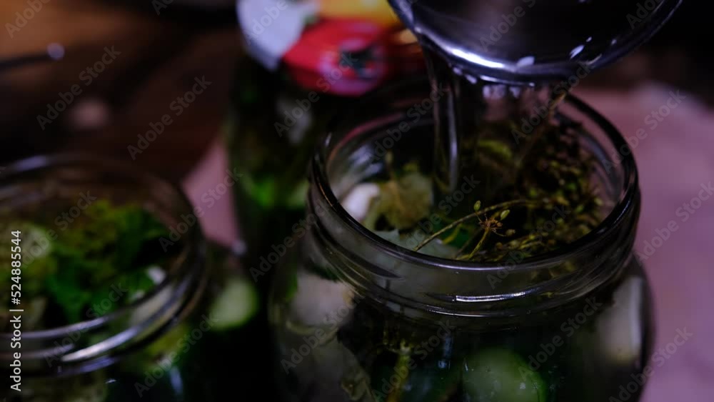 Pouring hot water on dill with cucumbers for steeping. Pouring hot water on dill with cucumbers for steeping.