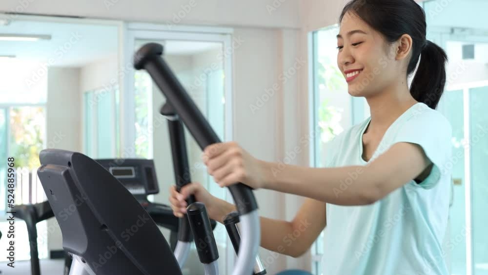 Elliptical, Energetic woman Warming Up on Cardio Machine for Gym Workout, Fitness and Wellness, Man exercising in the gym, Exercise for Health.
