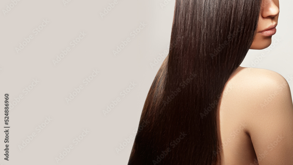 Naklejka premium Beautiful young woman with clean skin, beautiful straight shiny hair, fashion makeup. Beautiful smooth hairstyle