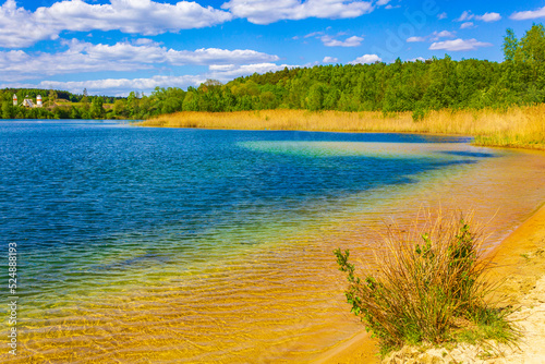 Fototapeta Naklejka Na Ścianę i Meble -  Beautiful quarry lake dredging pond lake blue turquoise water Germany.