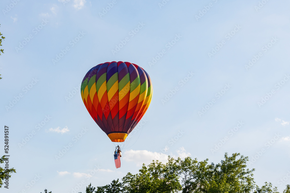 Hot air balloon flying with an American flag Hot air balloon flying with an American flag