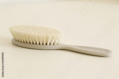 soft grey baby comb on white table