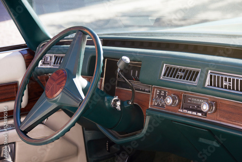 Steering wheel, dashboard and interior of an American classic car. Close-up shot. © Alfredo López