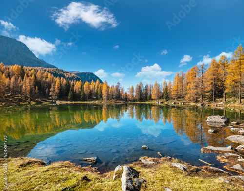 Fototapeta Naklejka Na Ścianę i Meble -  Autumn alpine mountain lake near San Pellegrino Pass, Trentino, Dolomites Alps, Italy.