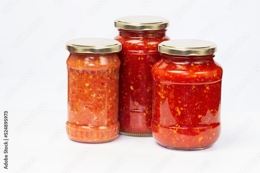 Hot sauce with chili peppers and spicy spices in jars Hot sauce with chili peppers and spicy spices in jars