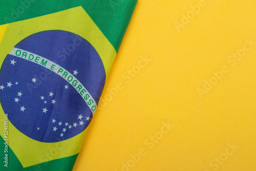 Wallpaper Mural LAURO DE FREITAS, BRAZIL - August 19, 2022 : brazilian flag under yellow background Torontodigital.ca