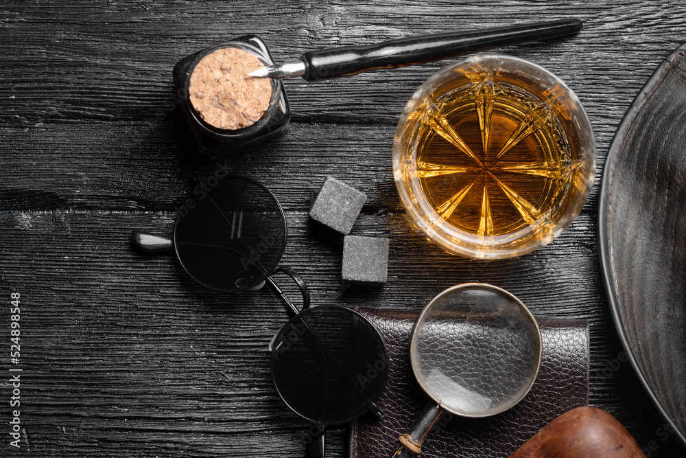 Whiskey in the drinking glass on the detective desk table background concept. Top view. Whiskey in the drinking glass on the detective desk table background concept. Top view.