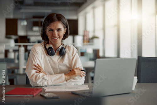 Attractive european business woman working laptop while sitting in cozy cafe. Blurred background