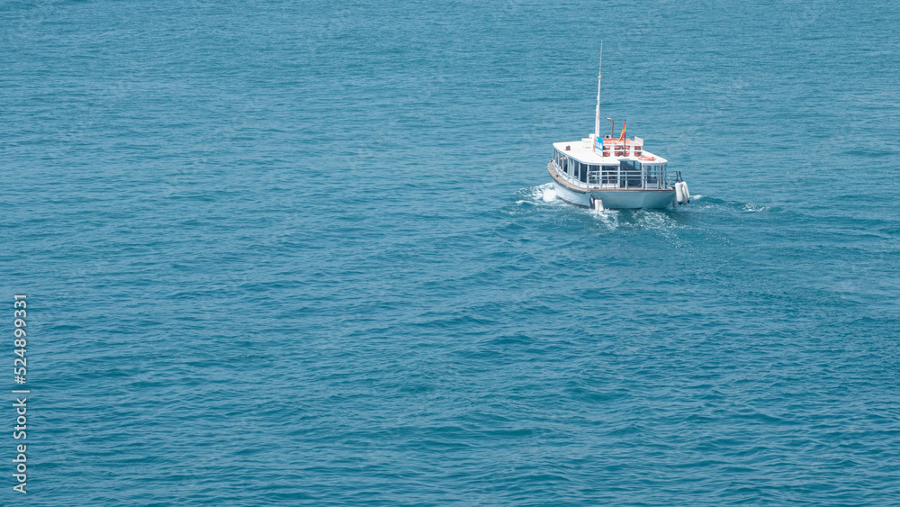 Small boat sailing through the Mediterranean sea Small boat sailing through the Mediterranean sea