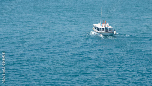Small boat sailing through the Mediterranean sea