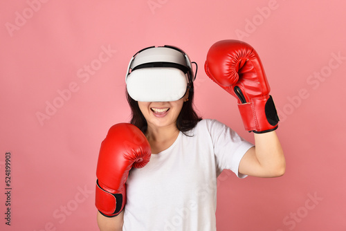 Obraz na płótnie Asian woman using vr glasses, Working out with boxing video games application from virtual reality headset, Young woman enjoy new fitness experience by vr technology, Studio shot. w salonie