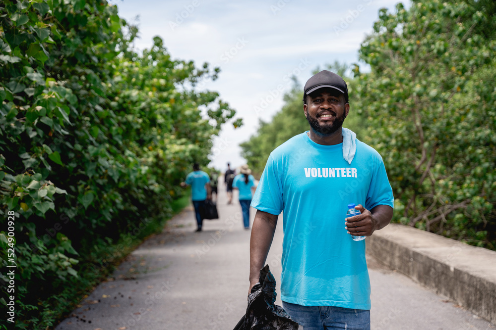 Portrait of volunteers clean discarded garbage and plastic in the forest park area. Portrait of volunteers clean discarded garbage and plastic in the forest park area.
