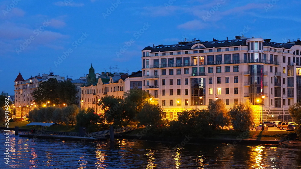 Urban landscapes. Night view of the embankment, the river and the buildings of St. Petersburg. Russia.