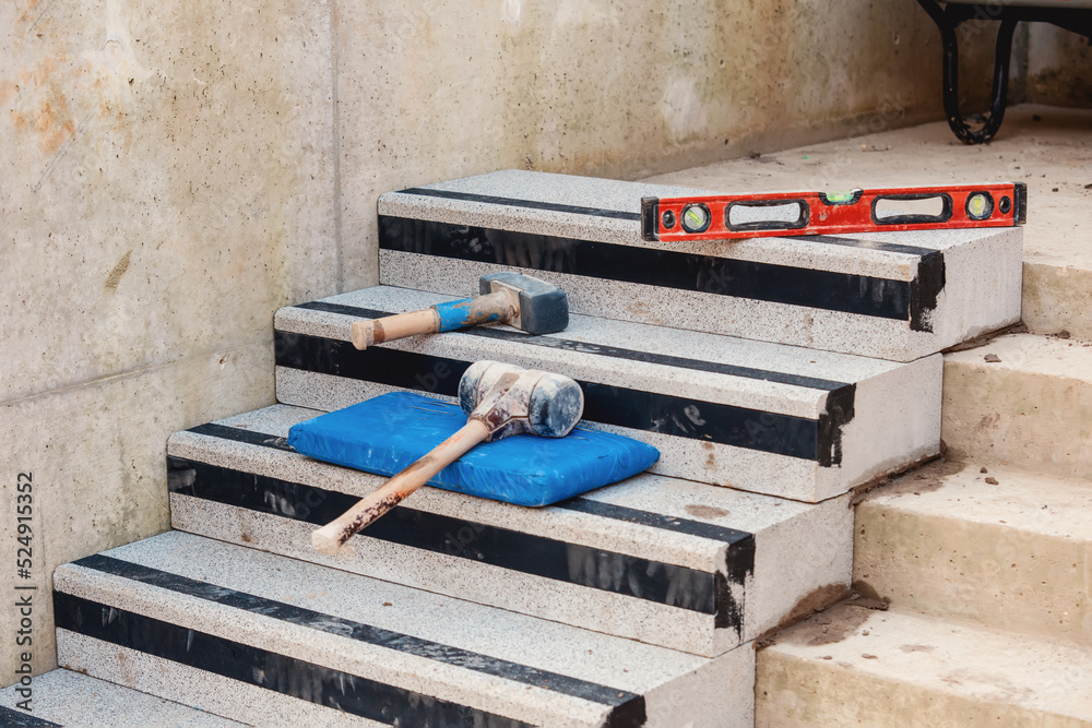 Concrete steps under construction as a team of builders install heavy