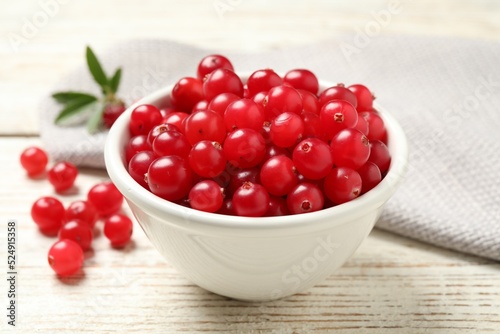 Tasty ripe cranberries on white wooden table, closeup