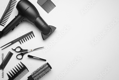 Flat lay composition with modern hair dryer on white background, space for text