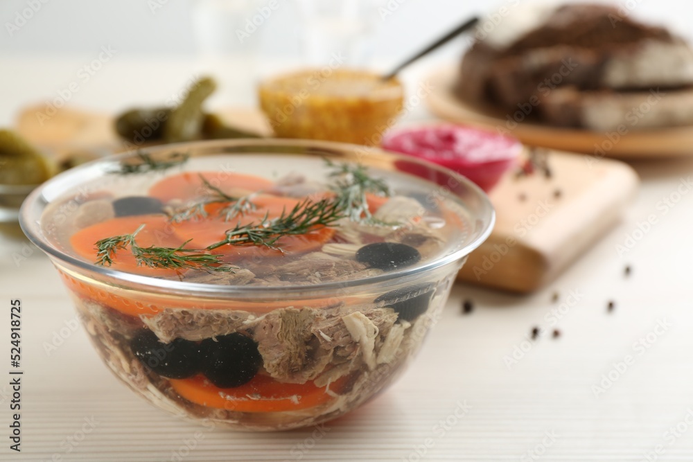 Delicious aspic with meat on white wooden table, closeup Delicious aspic with meat on white wooden table, closeup