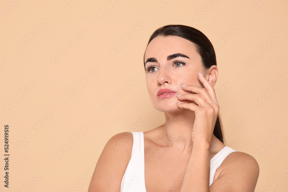 Beautiful woman with perfect skin under eyes on beige background. Space for text Beautiful woman with perfect skin under eyes on beige background. Space for text