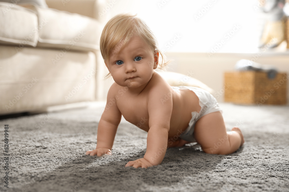 Cute little baby in diaper on carpet at home Cute little baby in diaper on carpet at home