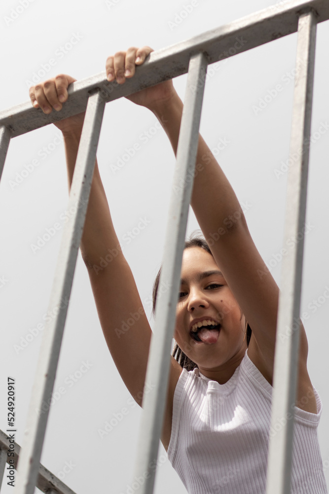 Naklejka premium Outdoor portrait of laughing teenage girl. Bottom view, close-up.