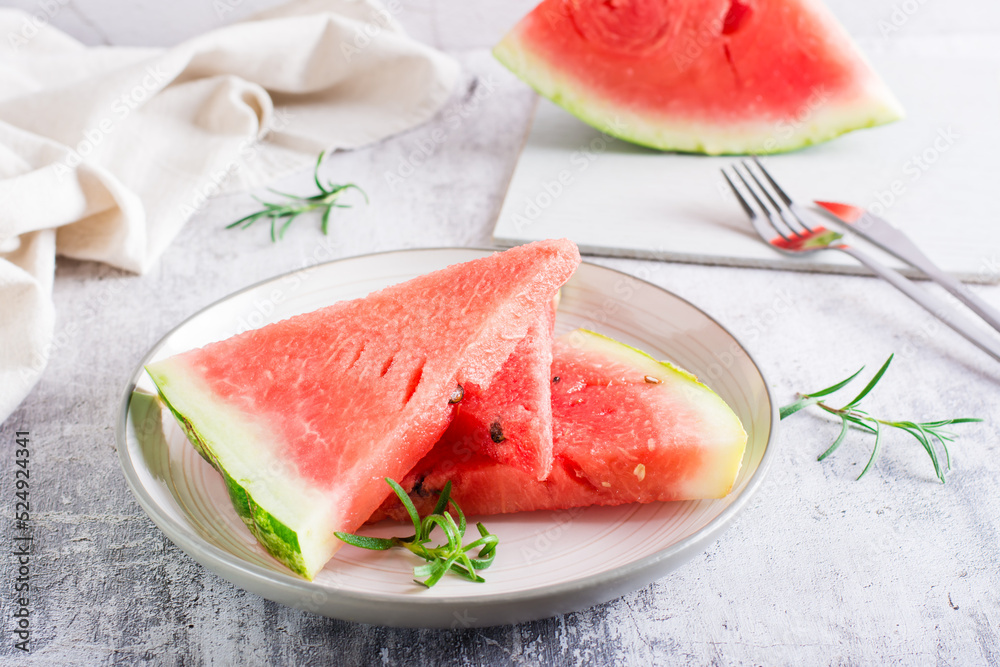 Pieces of fresh juicy watermelon on a plate on the table. Summer refreshment. Pieces of fresh juicy watermelon on a plate on the table. Summer refreshment.