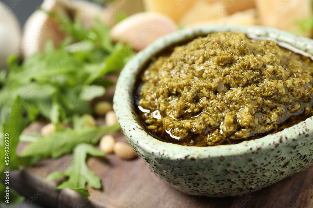 Bowl of tasty arugula pesto on table, closeup Bowl of tasty arugula pesto on table, closeup