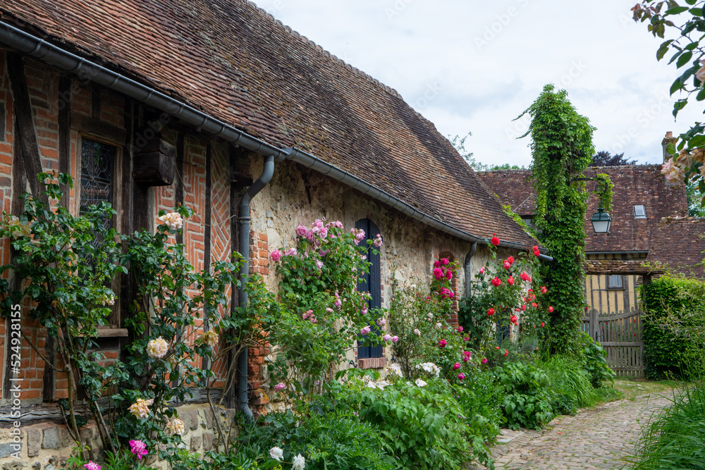 One of most beautiful french villages, Gerberoy - small historical village with half-timbered houses and colorful roses flowers, France One of most beautiful french villages, Gerberoy - small historical village with half-timbered houses and colorful roses flowers, France