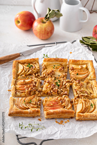 Apple tart with puff pastry tpped with walnuts and brown sugar photo