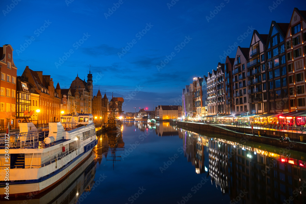 Scenic summer evening panorama of the architectural embankment pier canal river illumination of the Old Town GDANSK, POLAND