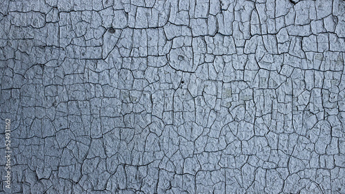 Cracks of old paint on a painted wall. Close up. Background, texture