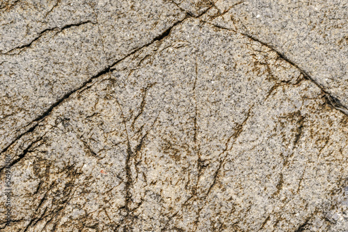 Texture of stone rock. Cracks in stone surface.