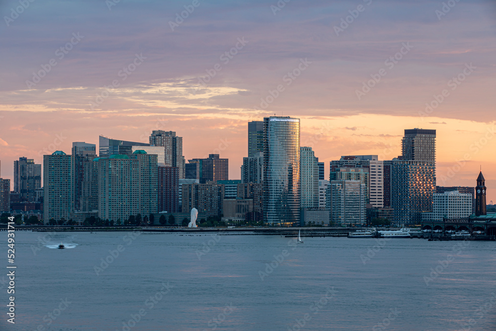 Panoramic dusk view of Jersey City, NJ across the Hudson 