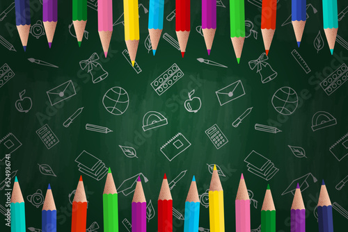 Back to school background. Colored pencils and a blackboard. Training, education, school supplies.