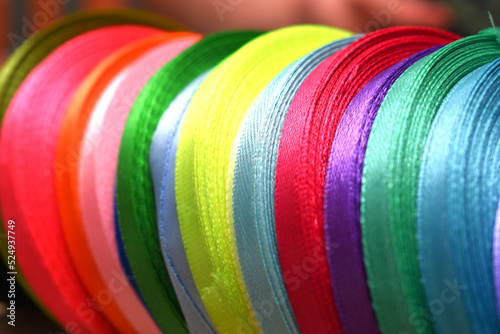 different rolls of colored ribbons stacked next to each other