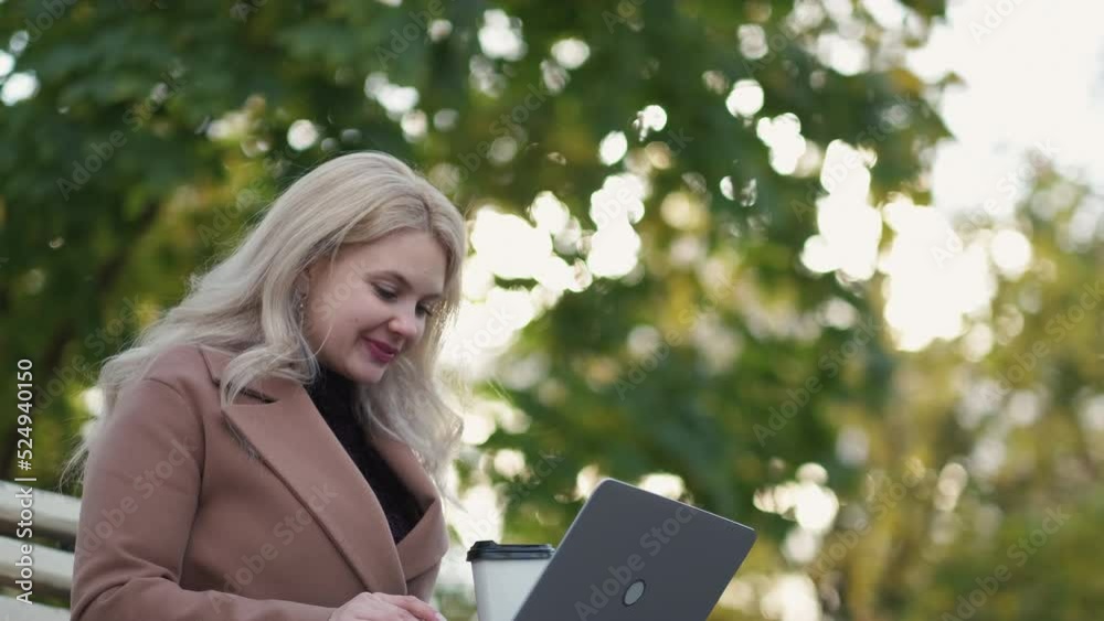 Virtual meeting. Inspired woman. Online education. Pretty happy lady sitting bench in park talking expressive on laptop in sunshine day. Virtual meeting. Inspired woman. Online education. Pretty happy lady sitting bench in park talking expressive on laptop in sunshine day.