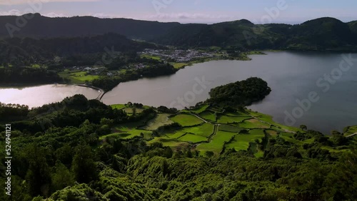 Aerial drone shot of  bridge between crater lakes Lagoa Verde and Lagoa Azul on San Miguel. Top view on bridge between two crater lakes in Azores. Green landscpe with lakes.  photo