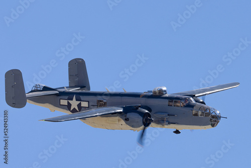 Close view of a WWII era bomber (B-25 Mitchell) approaching in beautiful light  photo