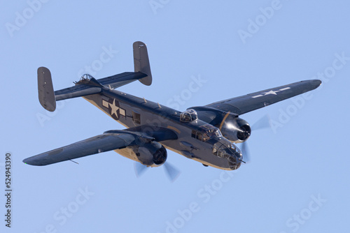 Close view of a WWII era bomber (B-25 Mitchell) approaching in beautiful light 