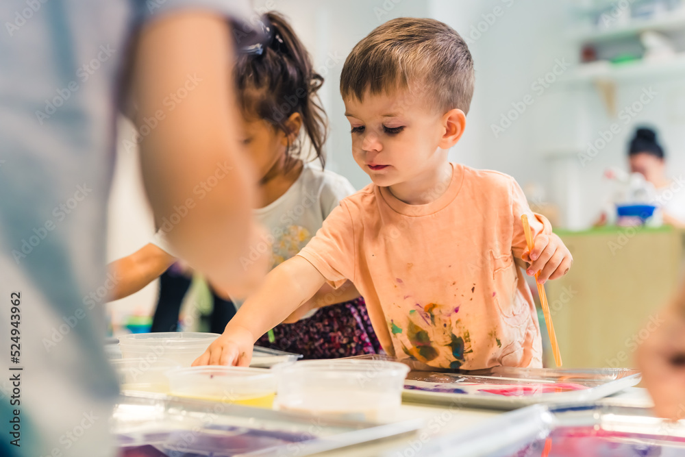 Fototapeta premium let's paint together, kids in the kindergarten. High quality photo